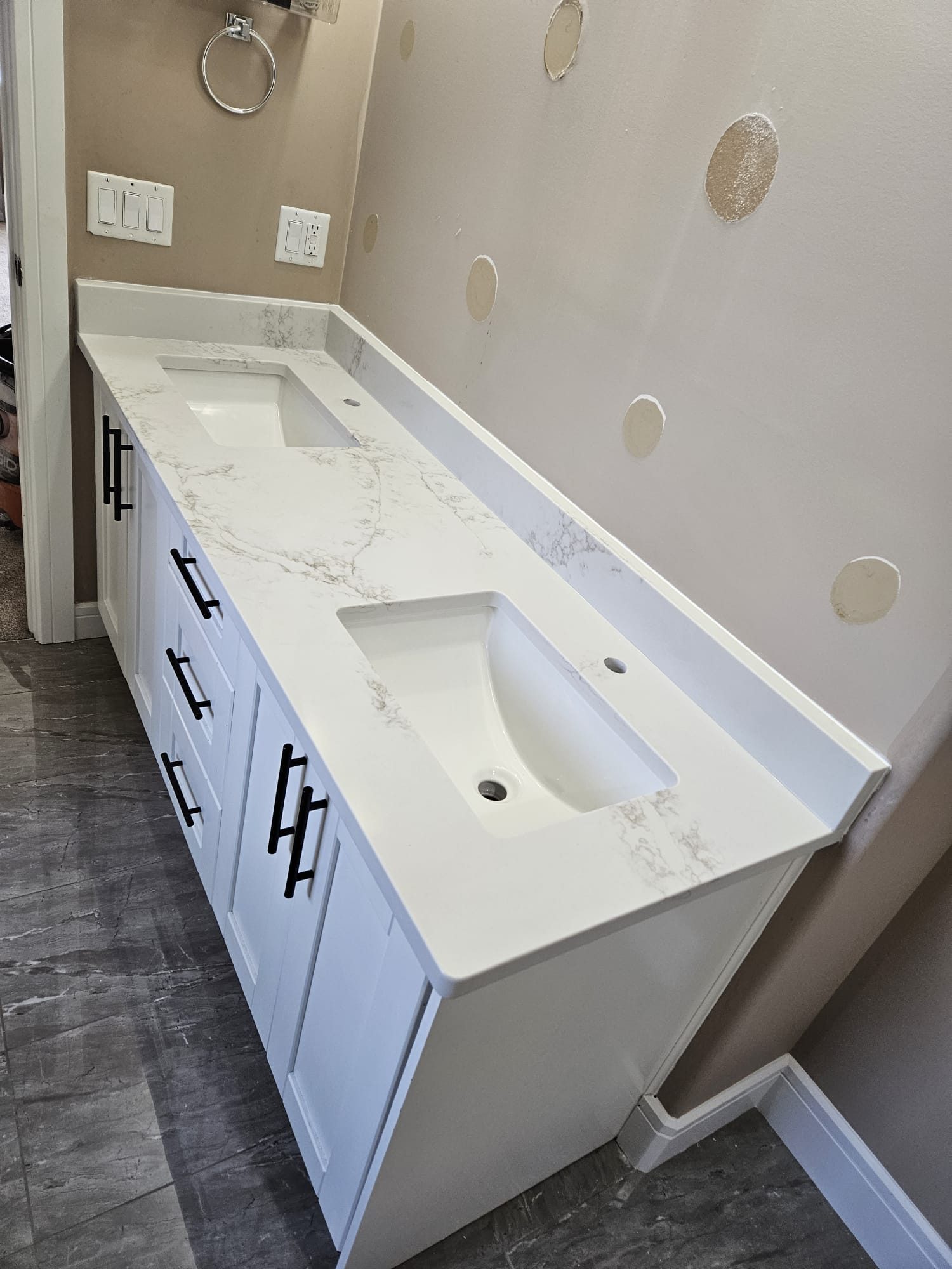 Double bathroom vanity with a quartz top and two basins