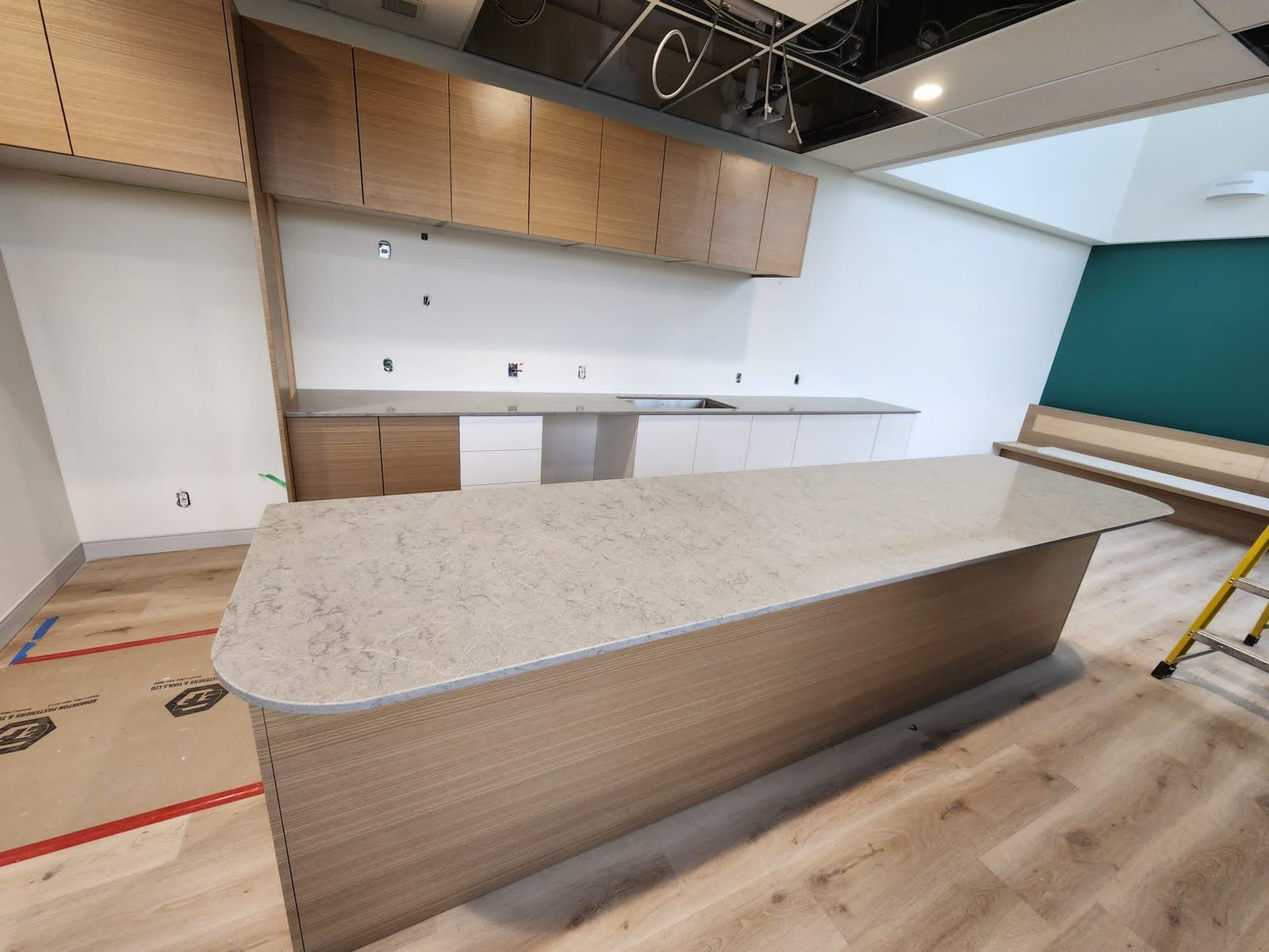 Large island countertop being fitted during fabrication