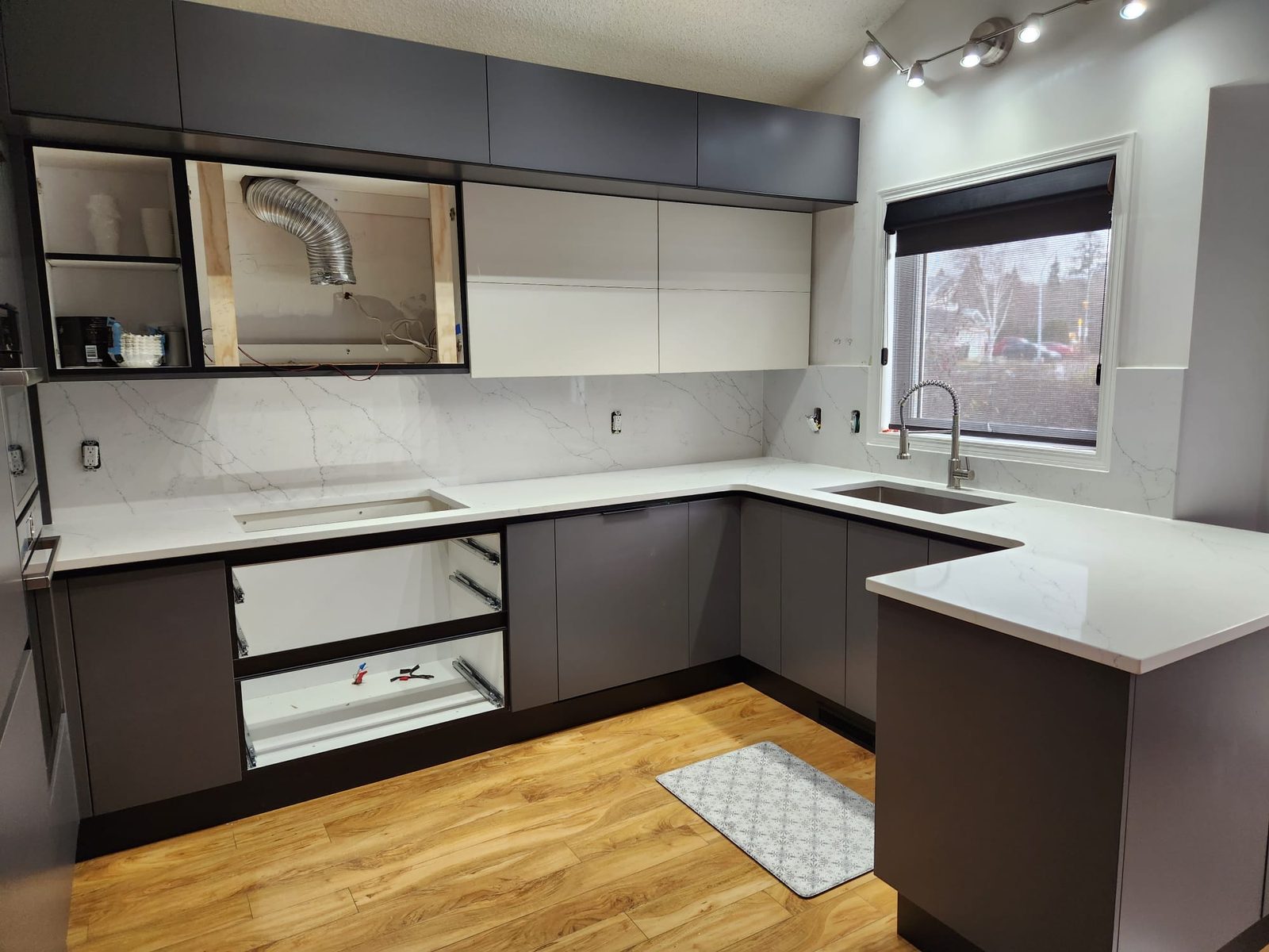 Two-tone Edmonton kitchen with light stone countertops