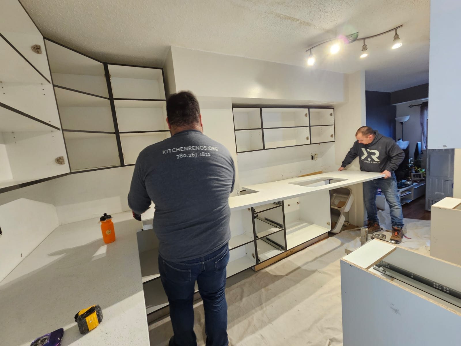 Javier and his crew setting a large quartz countertop in place on site in Edmonton